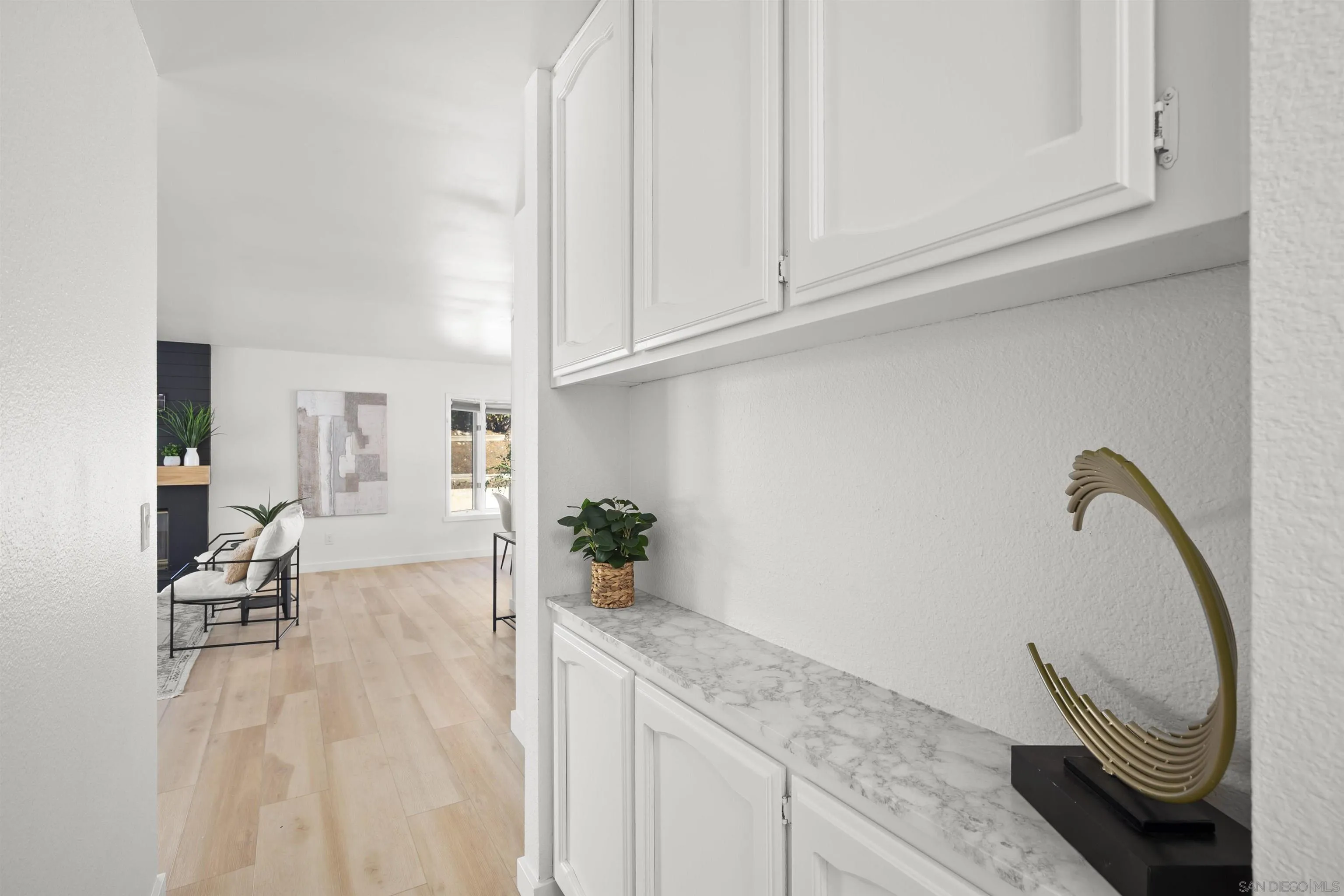 2321 Farrington Drive El Cajon, CA 92020 - Photo 26 of 47 a living room with granite countertop white cabinets and a sink