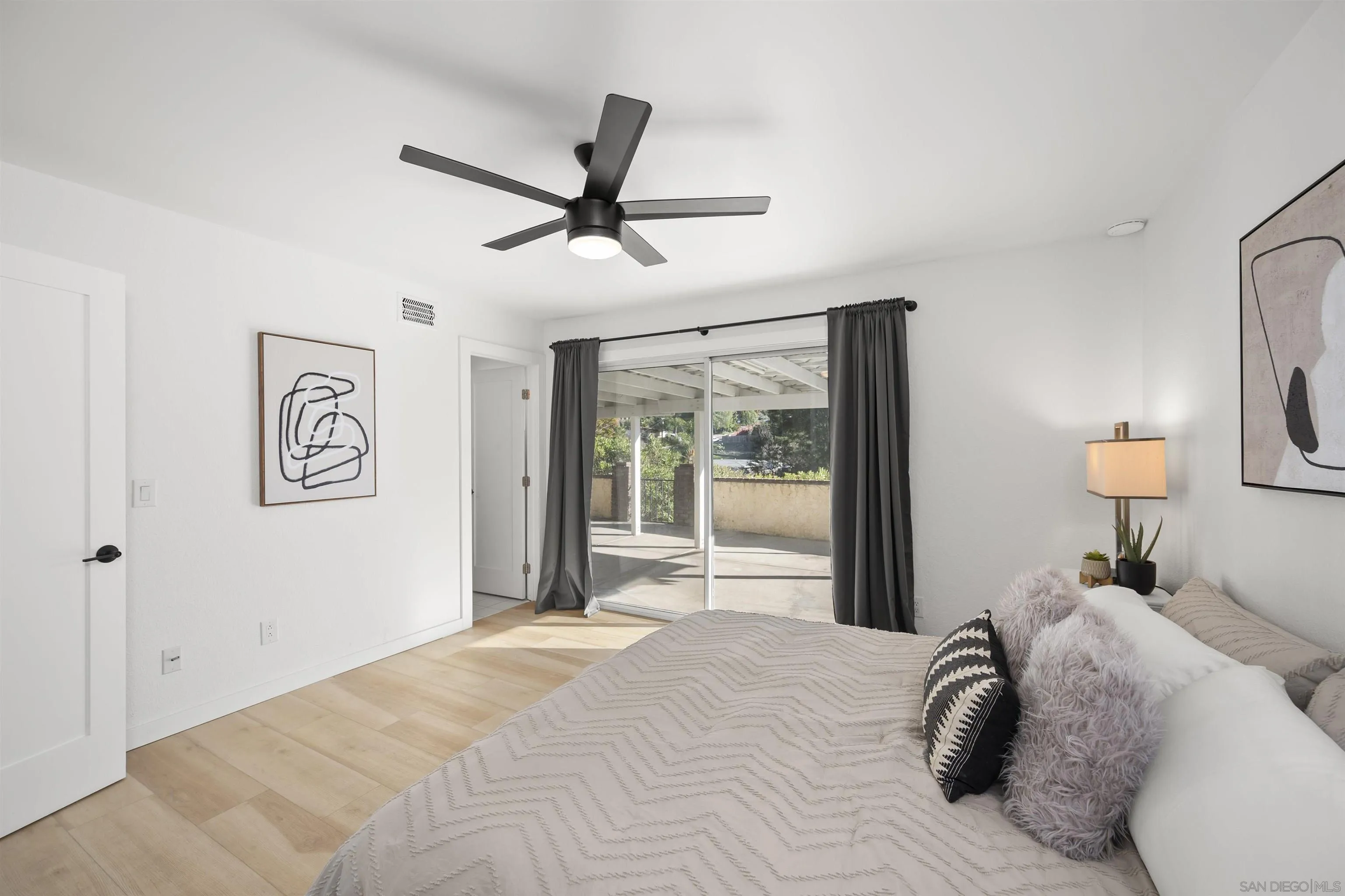 2321 Farrington Drive El Cajon, CA 92020 - Photo 27 of 47 a bedroom with a large bed and a chandelier