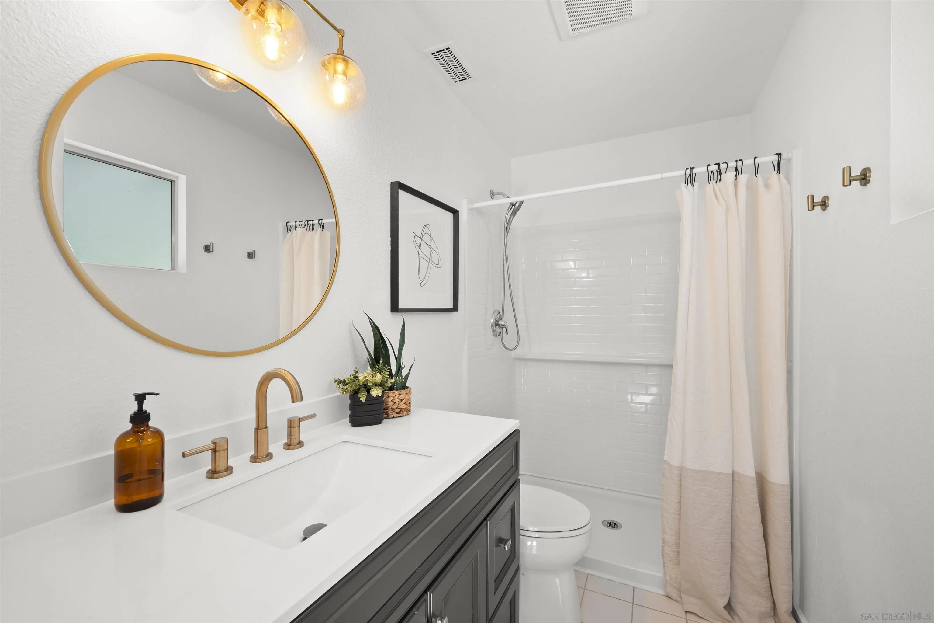 2321 Farrington Drive El Cajon, CA 92020 - Photo 30 of 47 a bathroom with a sink a toilet and a mirror