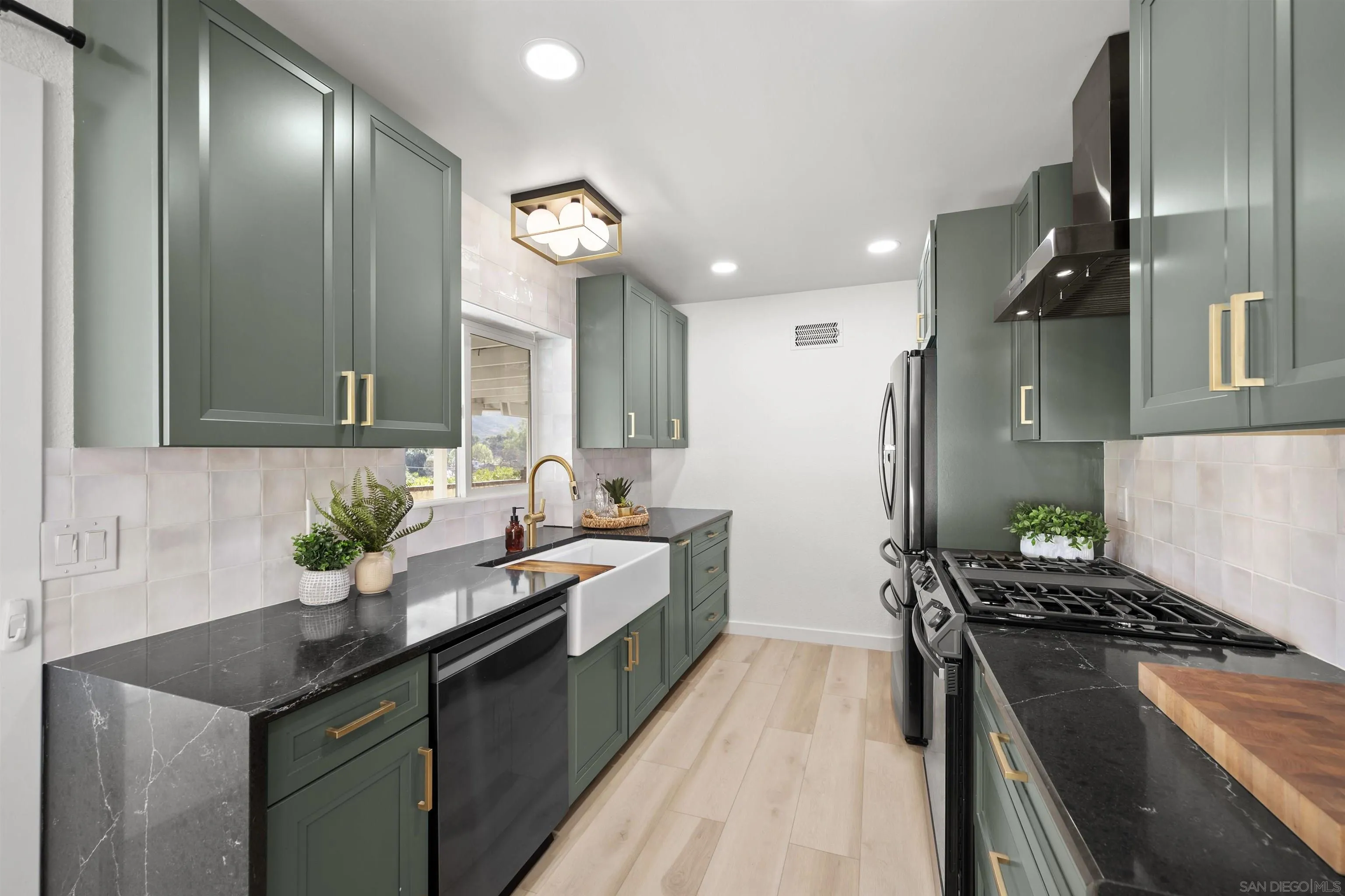 2321 Farrington Drive El Cajon, CA 92020 - Photo 3 of 47 a kitchen with a sink stove and cabinets