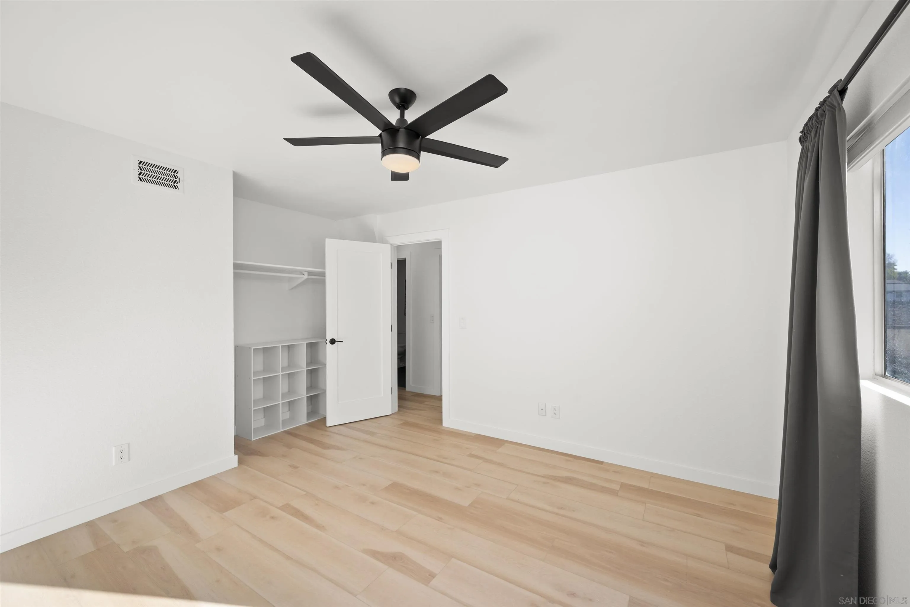 2321 Farrington Drive El Cajon, CA 92020 - Photo 32 of 47 a view of a big room with wooden floor and a ceiling fan