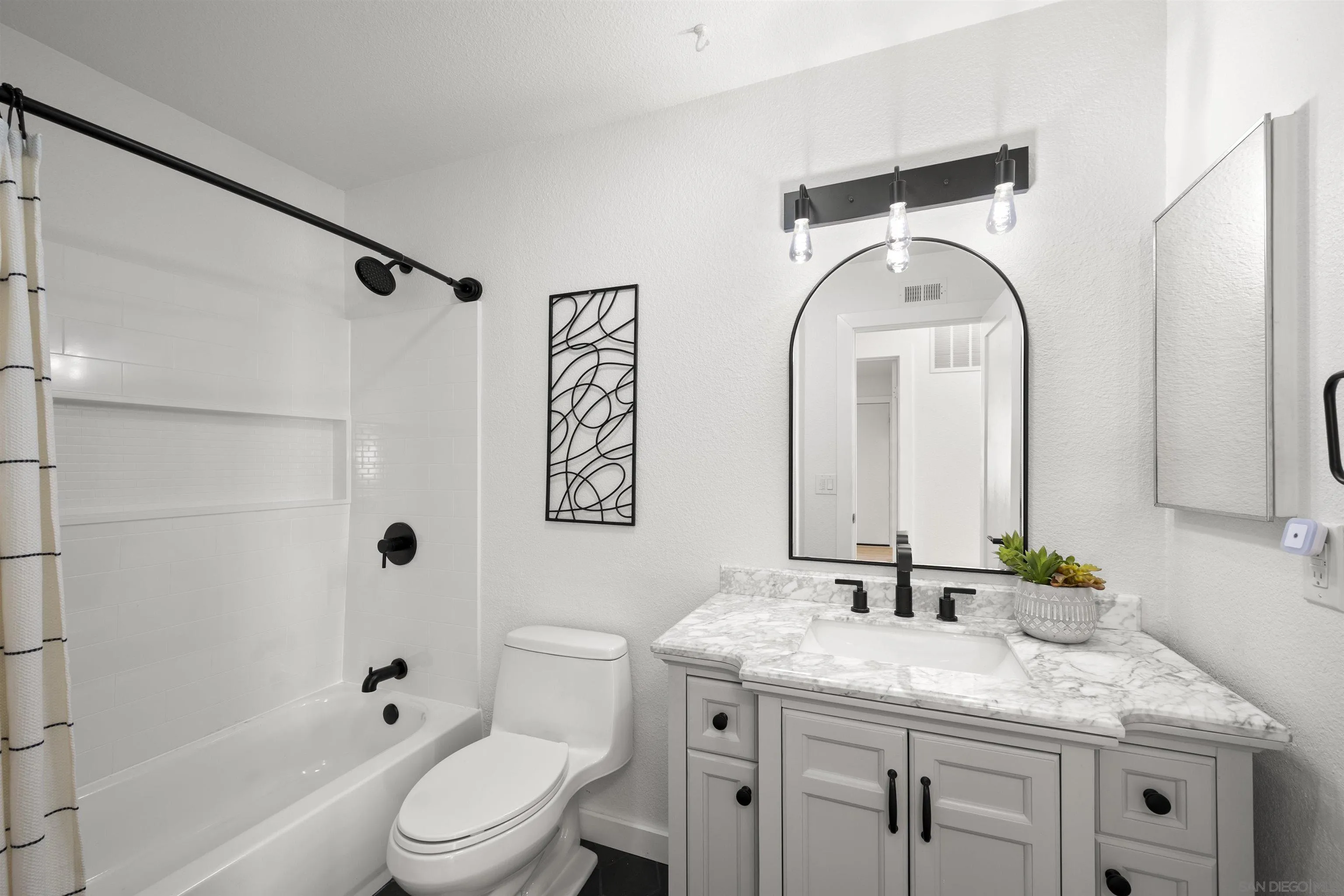 2321 Farrington Drive El Cajon, CA 92020 - Photo 33 of 47 a bathroom with a granite countertop sink a mirror a toilet and shower