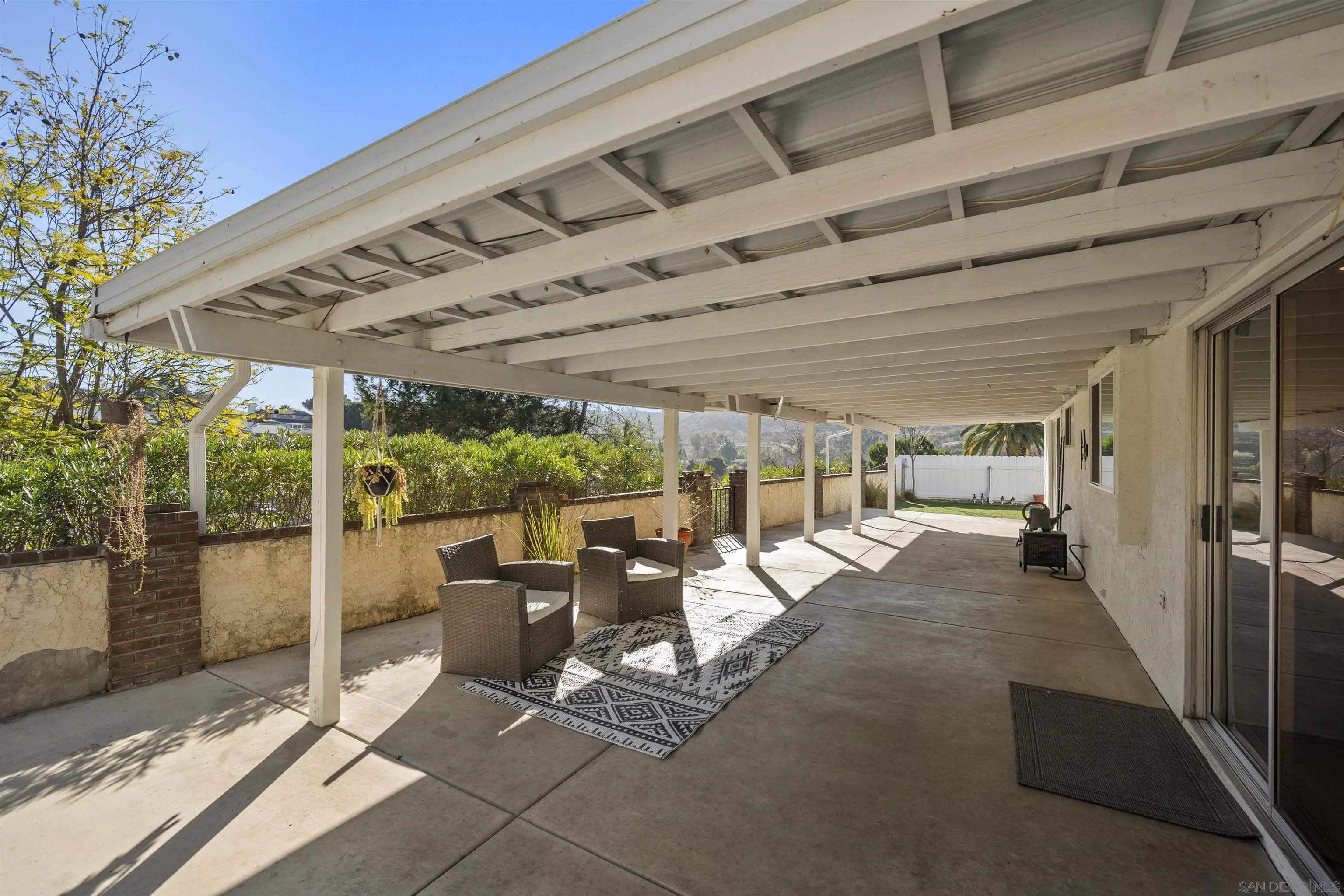 2321 Farrington Drive El Cajon, CA 92020 - Photo 35 of 47 a view of a patio with table and chairs next to a yard
