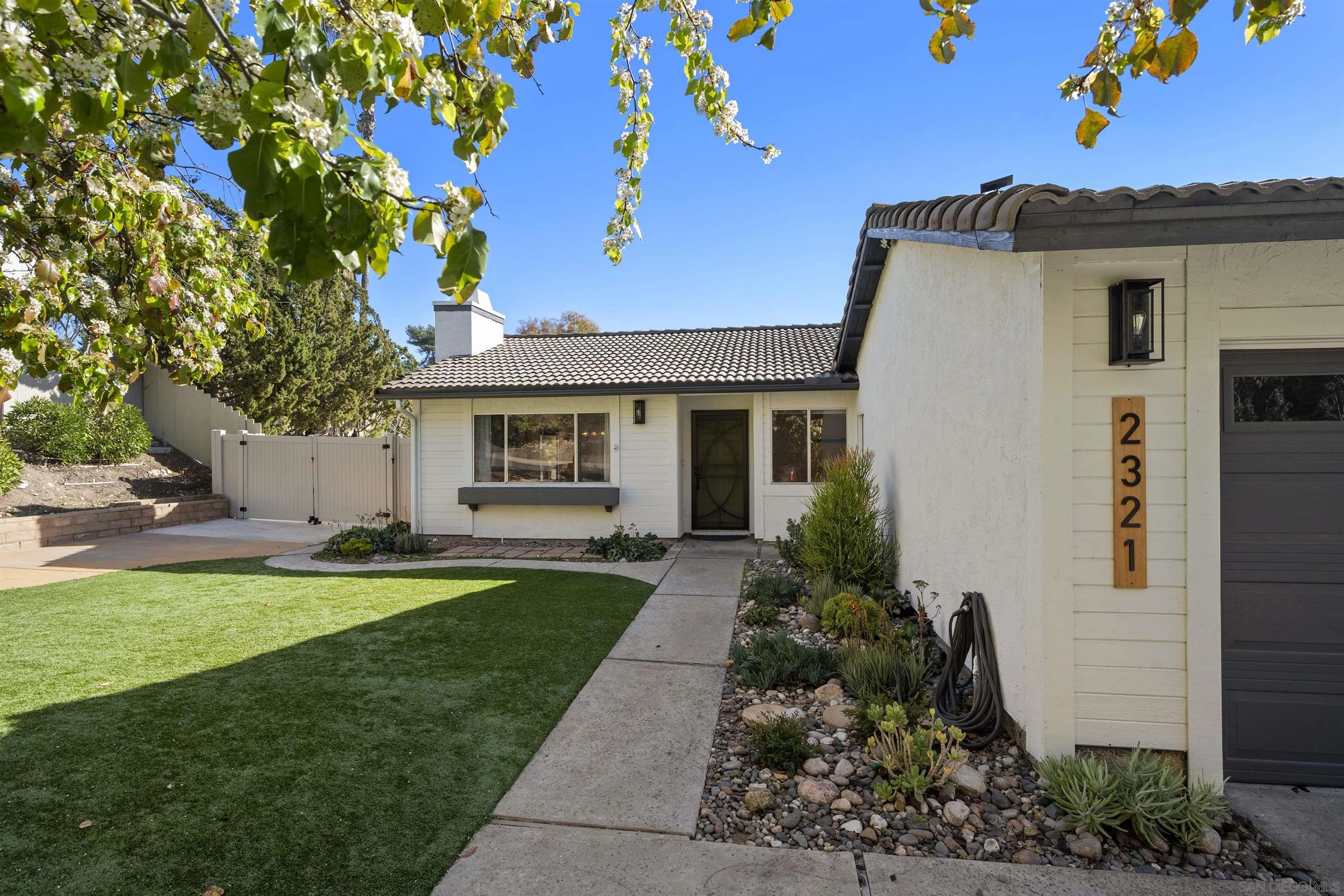 2321 Farrington Drive El Cajon, CA 92020 - Photo 4 of 47 a front view of a house with a garden