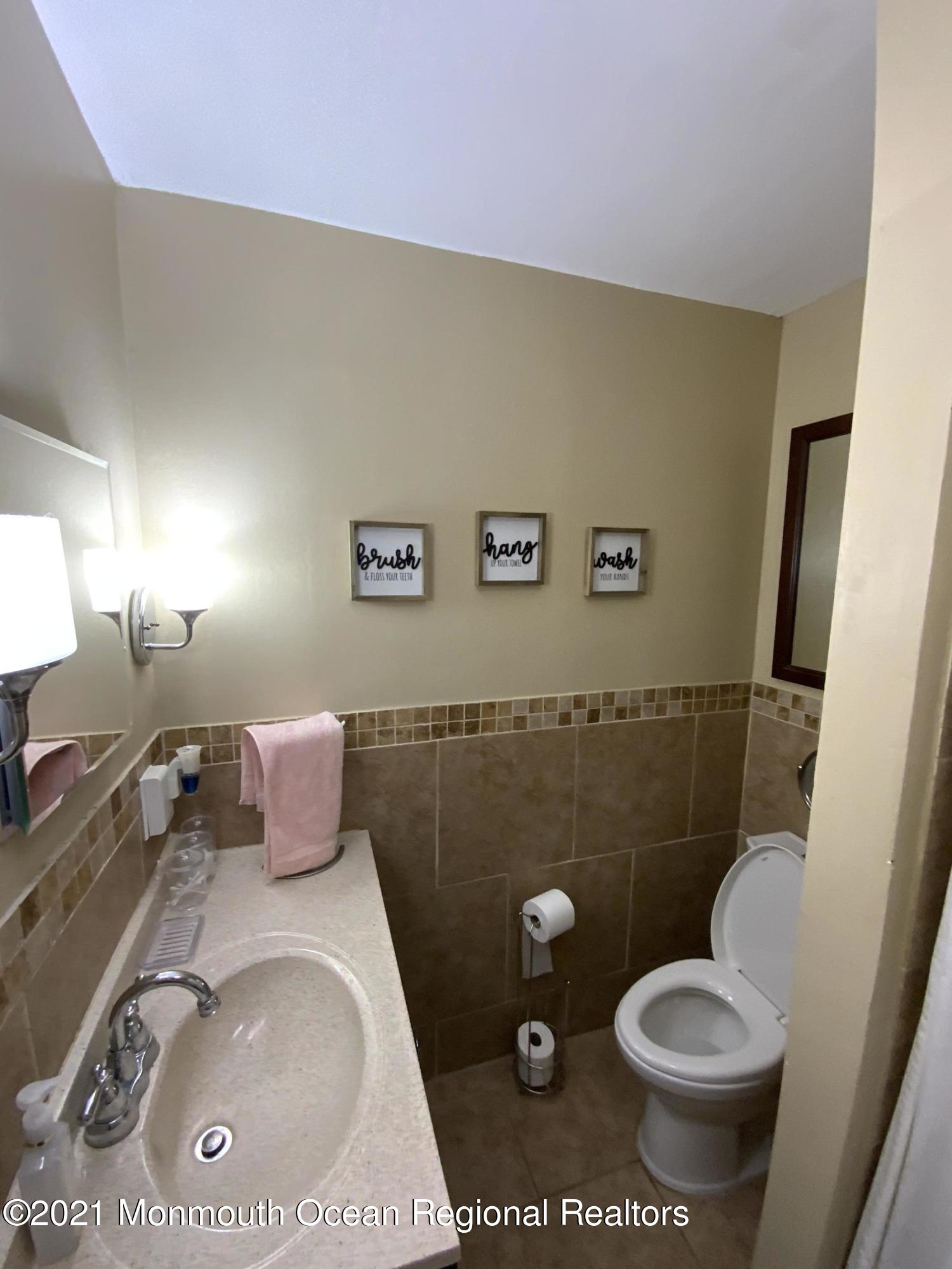 151 Ravine Drive Matawan, NJ 07747 - Photo 16 of 23 a bathroom with a sink and a toilet