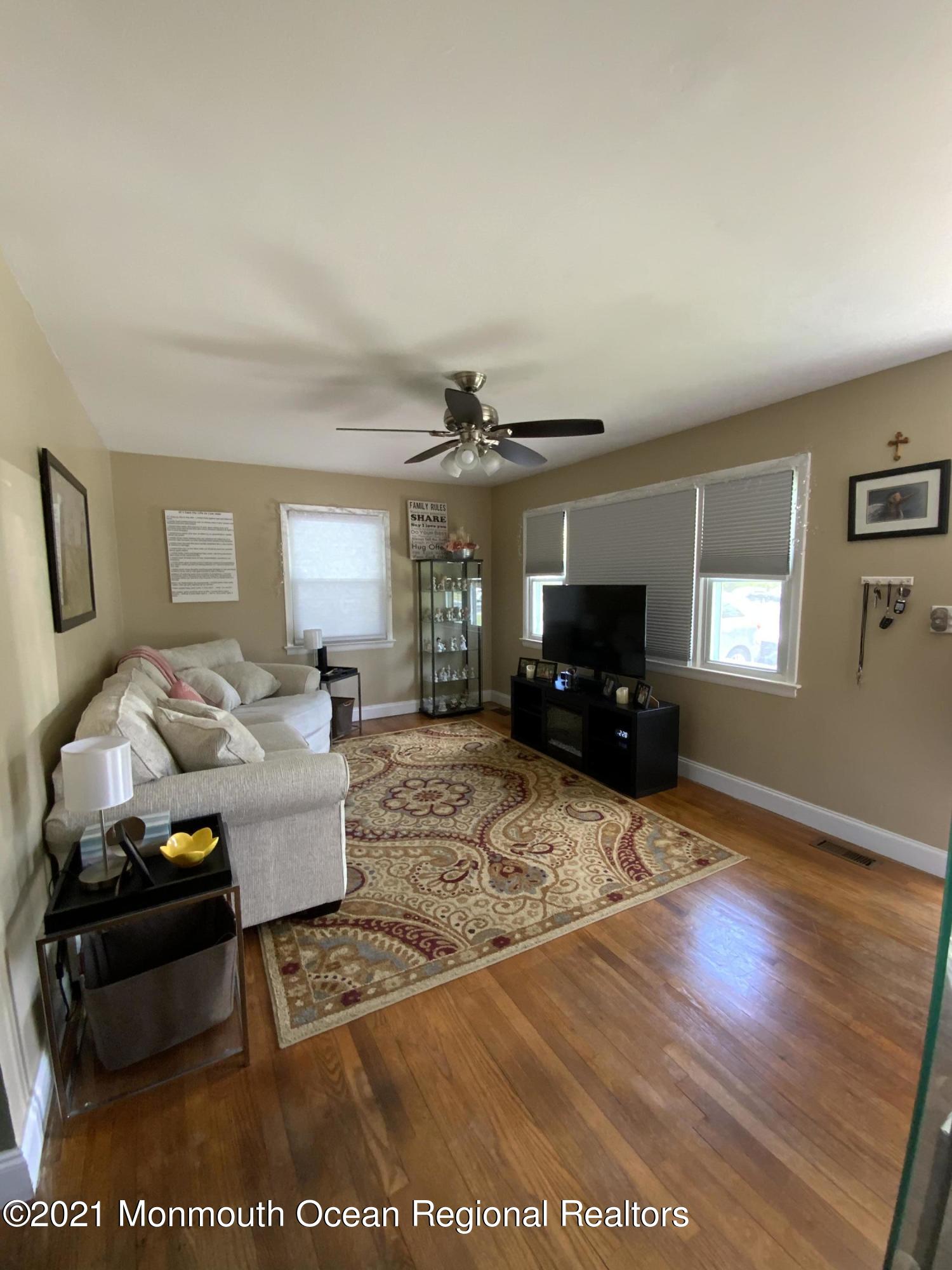 151 Ravine Drive Matawan, NJ 07747 - Photo 4 of 23 a living room with furniture and a flat screen tv