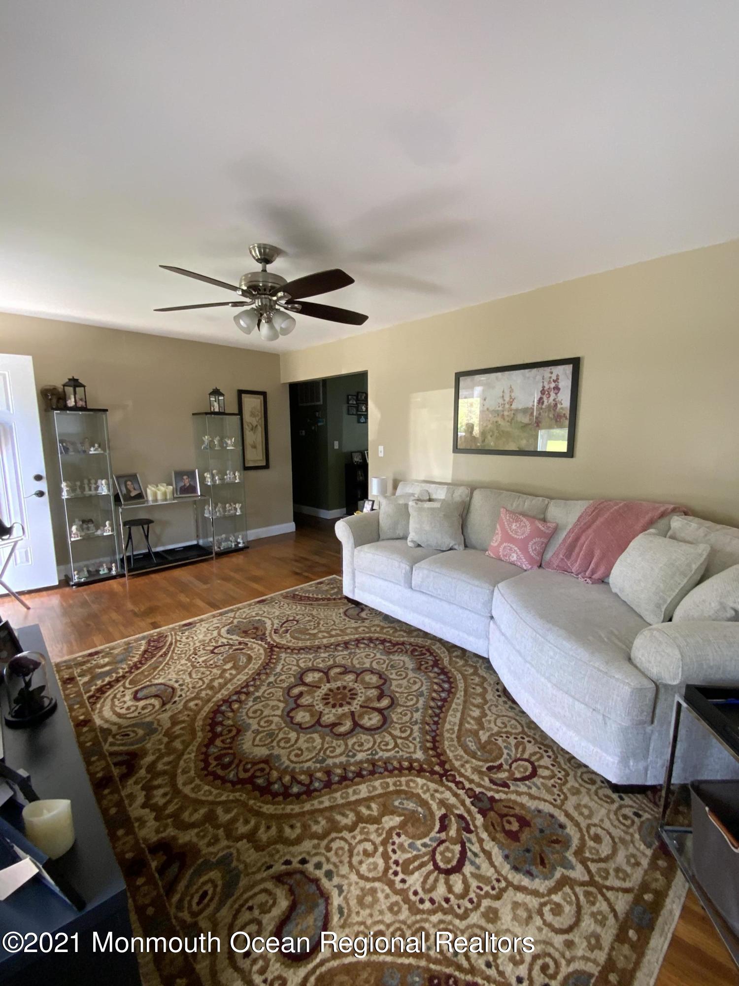 151 Ravine Drive Matawan, NJ 07747 - Photo 5 of 23 a living room with a couch and a dining table