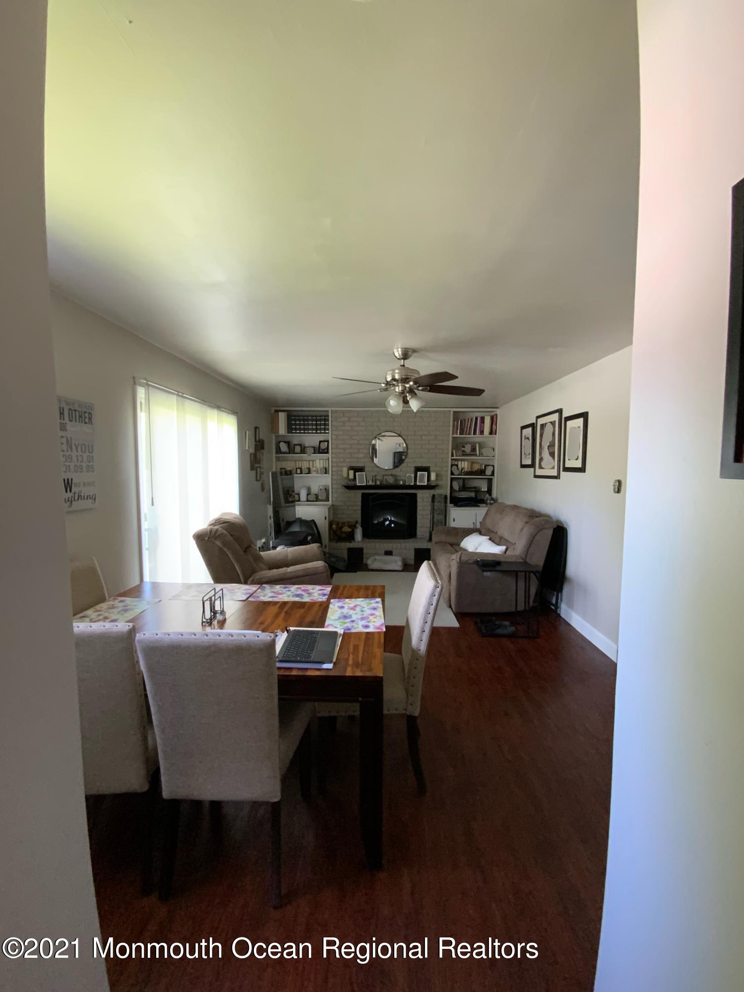 151 Ravine Drive Matawan, NJ 07747 - Photo 7 of 23 a living room with furniture a rug potted plant and a window