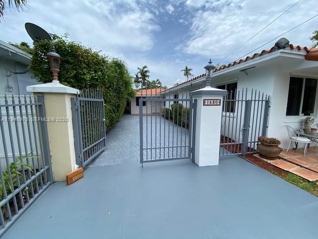 a view of a house with wooden fence and floor to ceiling window