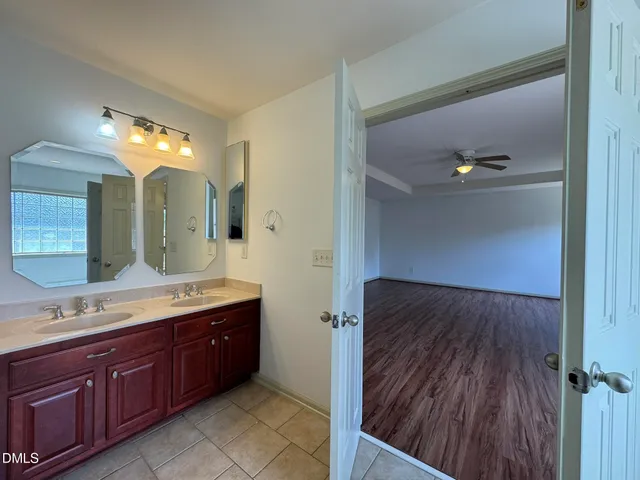 a spacious bathroom with a double vanity sink and a mirror