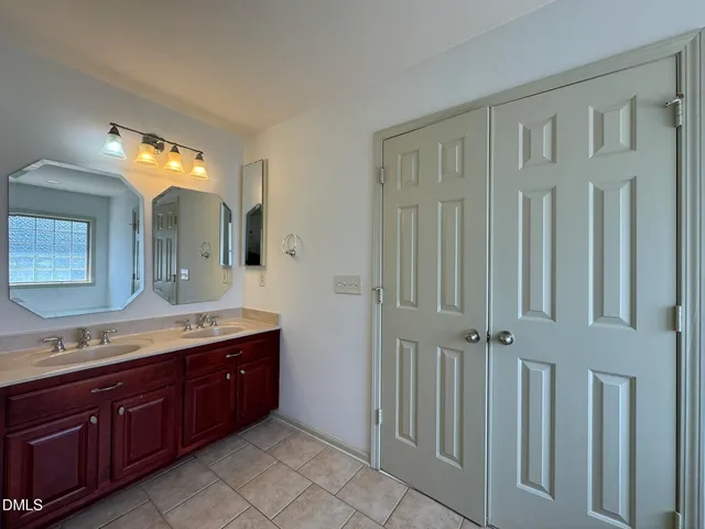a spacious bathroom with a granite countertop mirror and a sink