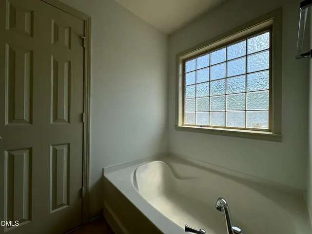 a bathroom with a tub and sink