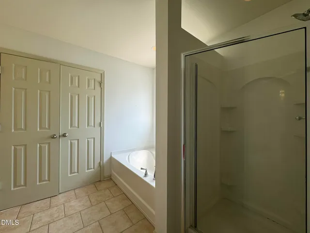 a bathroom with a bathtub and shower