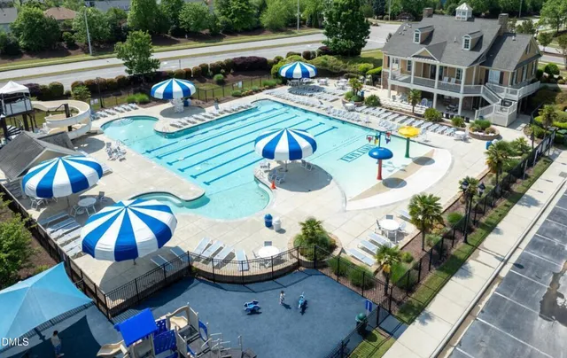 an aerial view of a house with outdoor seating