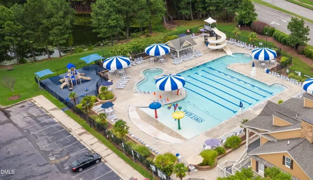 an aerial view of a swimming pool with a patio