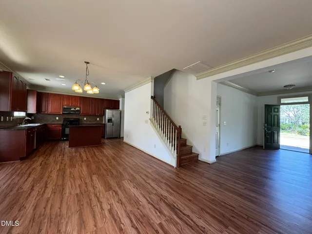 a view of kitchen with cabinets and wooden floor