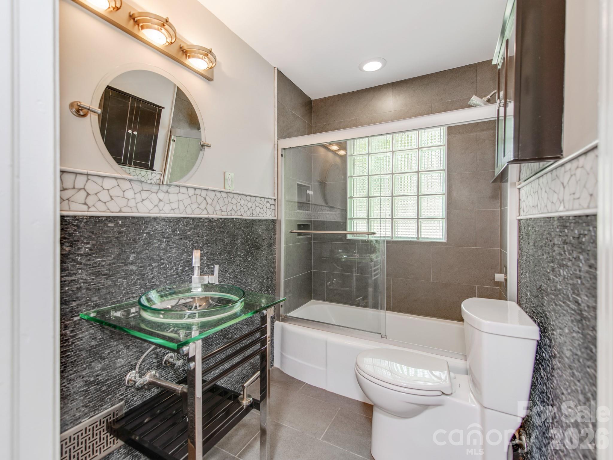 113 Falls Street Morganton, NC 28655 - Photo 15 of 33 a bathroom with a toilet a sink and bathtub