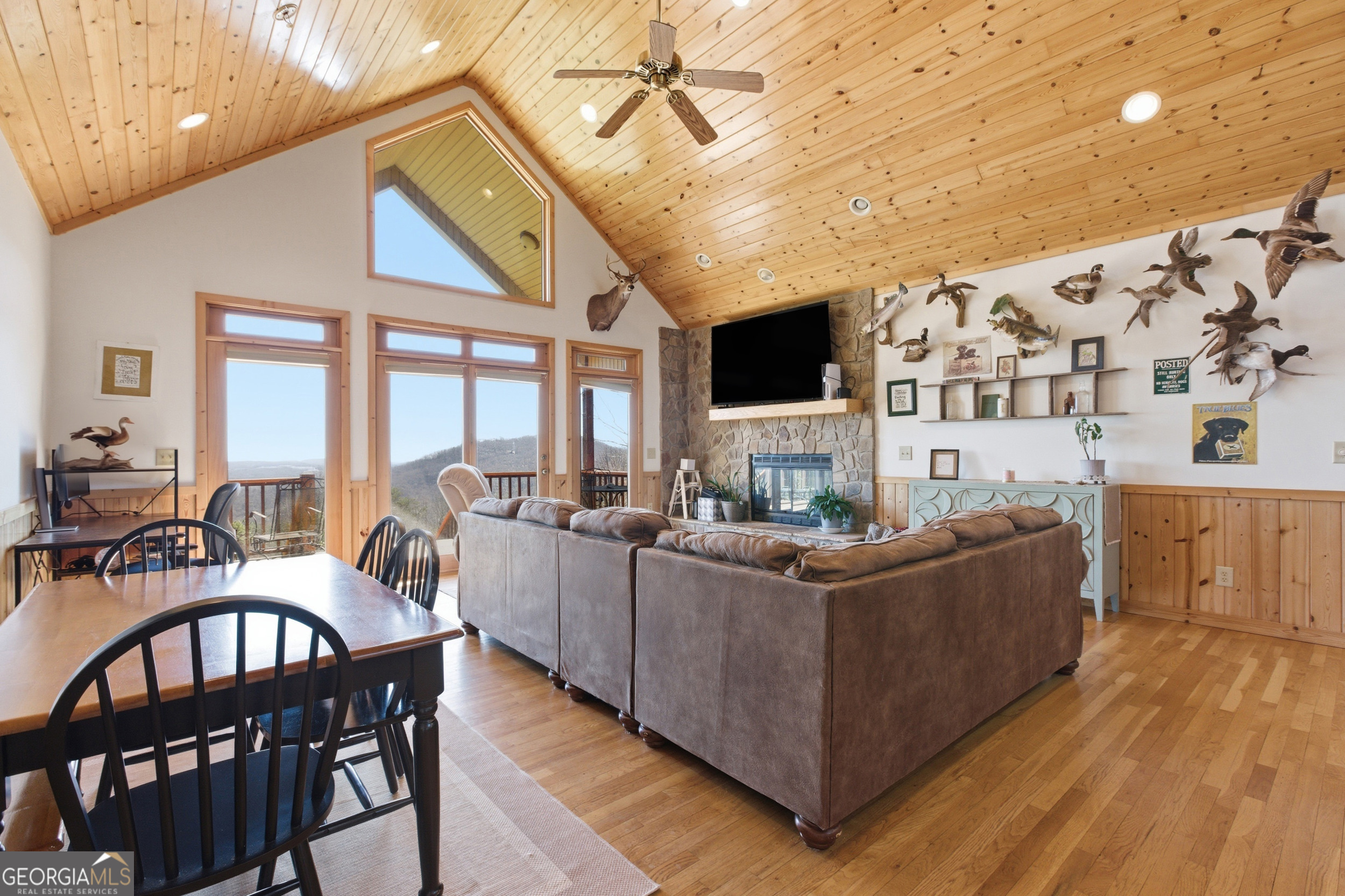 2280 Germany Road Clayton, GA 30525 - Photo 11 of 70 a living room with furniture a flat screen tv and a floor to ceiling window