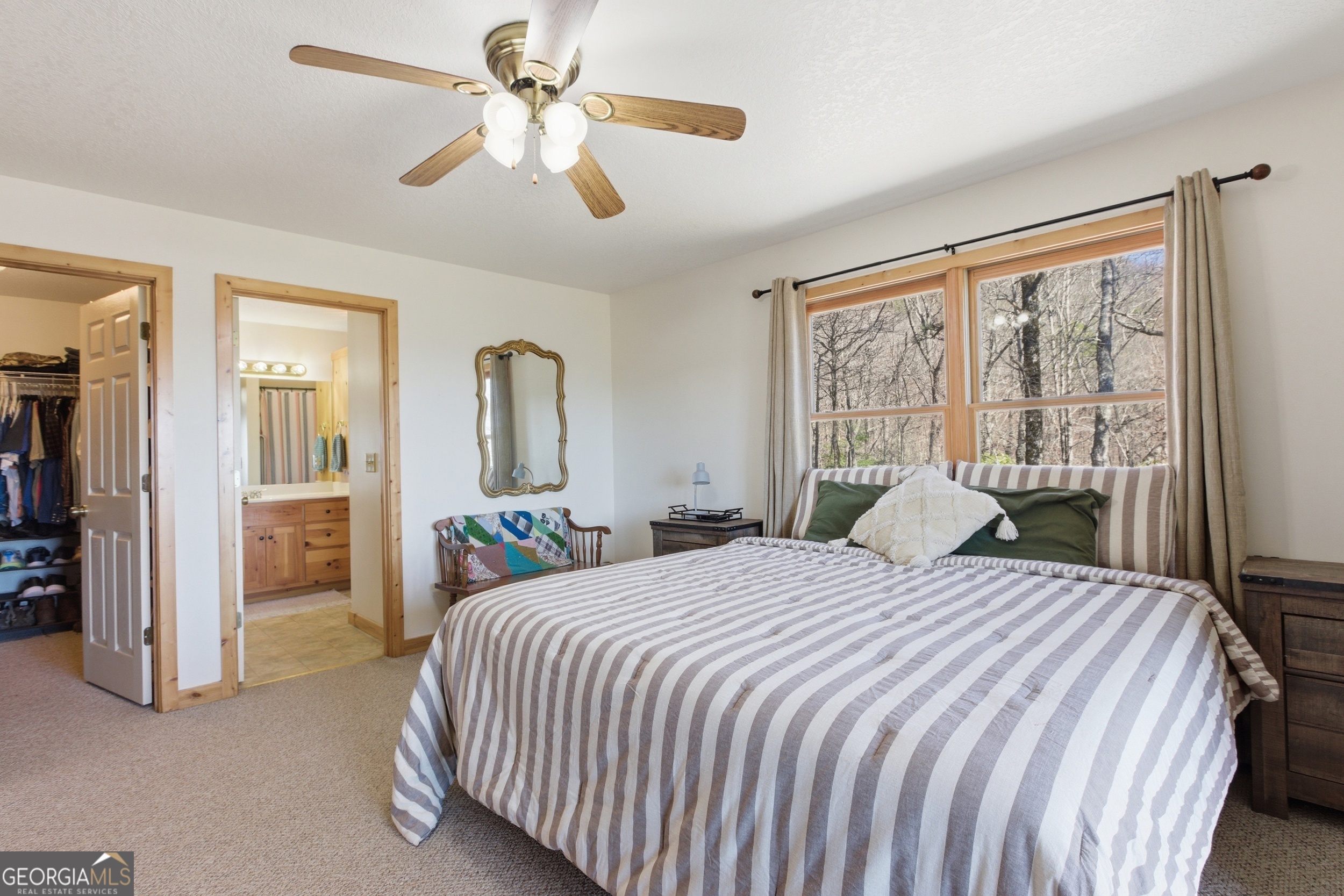 2280 Germany Road Clayton, GA 30525 - Photo 18 of 70 a bedroom with a large bed and a chandelier