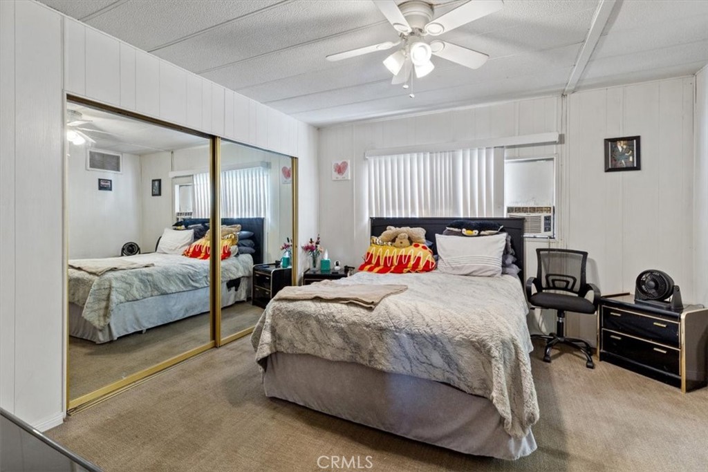 300 North Rampart Street, Unit 195 Orange, CA 92868 - Photo 13 of 25 a bedroom with bed and a chandelier