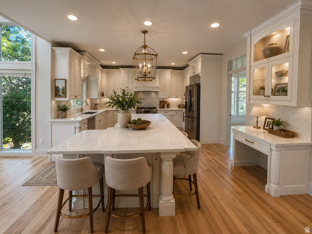 11902 Autumn Ridge Drive East Sandy, UT 84092 - Photo 10 of 20 Open-concept kitchen featuring white cabinetry, light wood-finish flooring, and an expansive island with a light-toned countertop AI-staged or enhanced