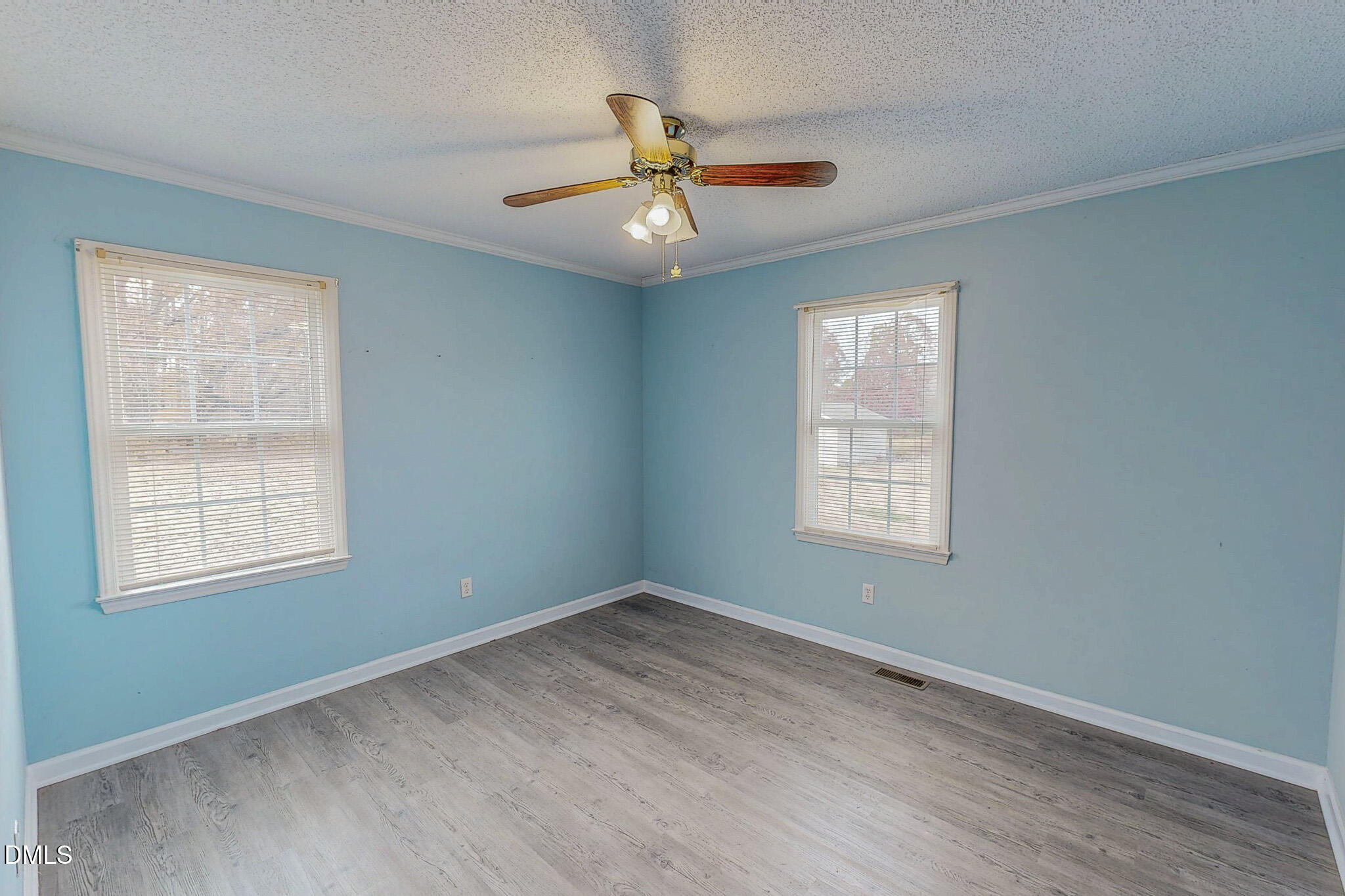111 Fox Crossing Drive Roxboro, NC 27574 - Photo 16 of 25 an empty room with wooden floor ceiling fan and windows
