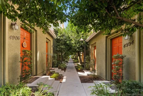 a view of a pathway of house with potted plants