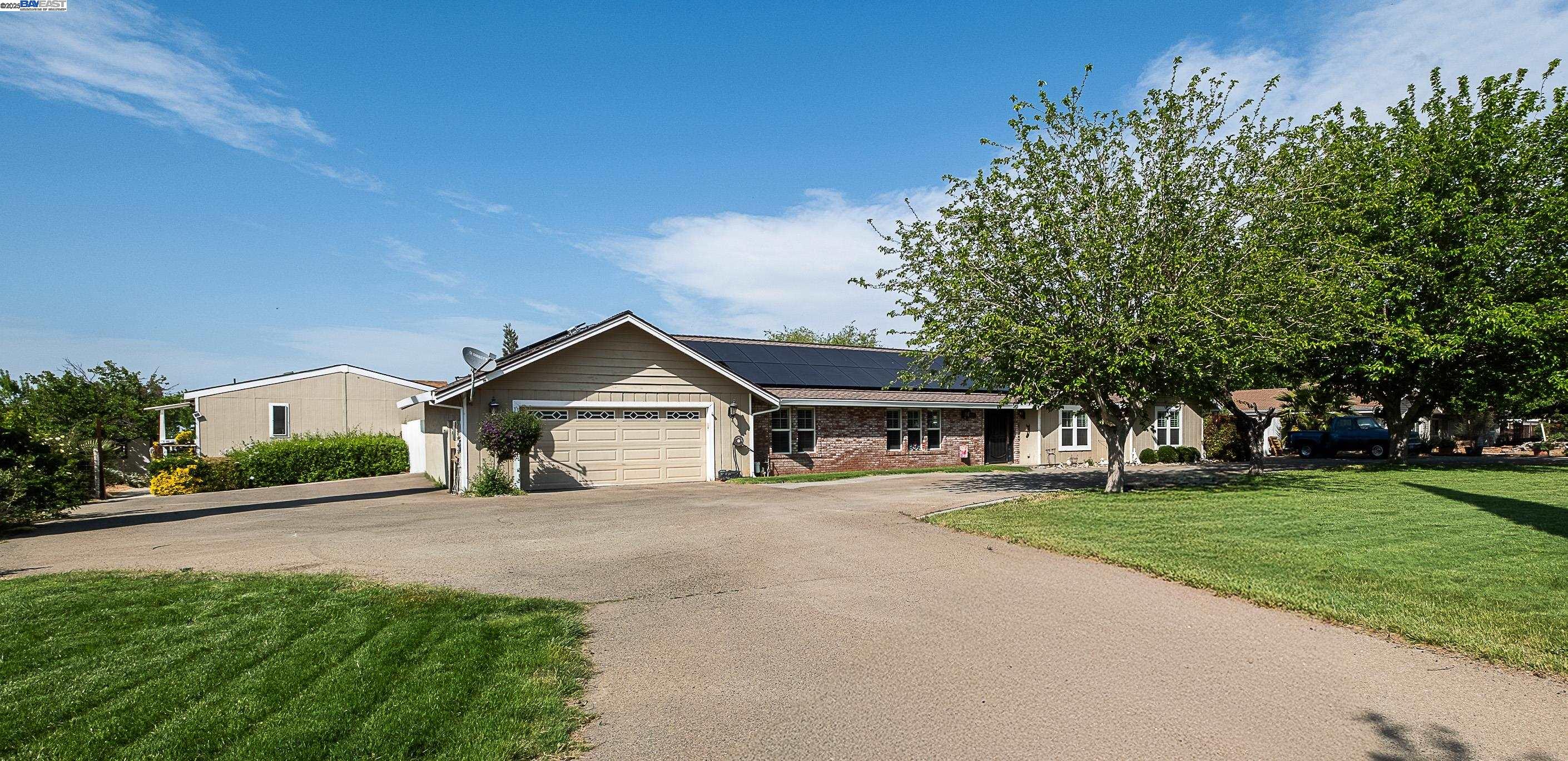 7737 Stearman Road Tracy, CA 95377 - Photo 1 of 1 a front view of a house with a garden