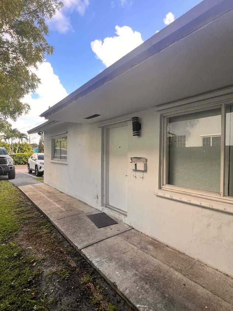 726 Southwest 7th Street, Unit 12 Hallandale Beach, FL 33009 - Photo 3 of 5 a view of a car parked front of a house