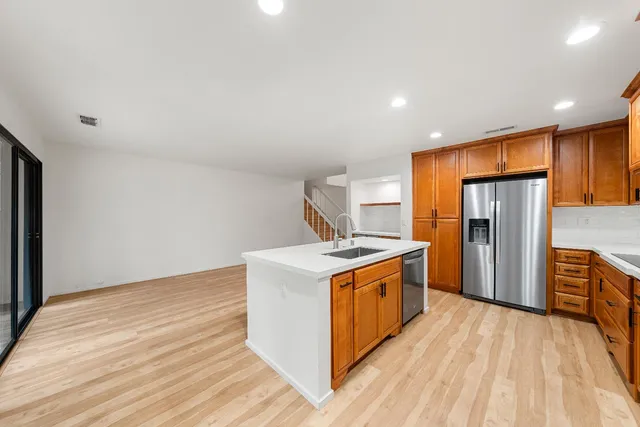 a kitchen with stainless steel appliances granite countertop a stove and a refrigerator