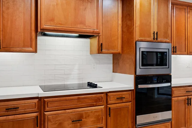 a close view of a sink and a microwave oven in a kitchen