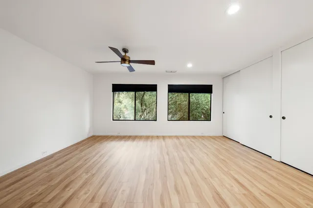 wooden floor in an empty room with a window