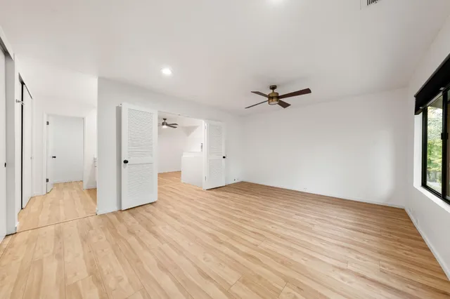 a view of a livingroom with wooden floor and window