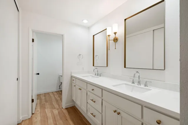 a bathroom with a double vanity sink and a mirror