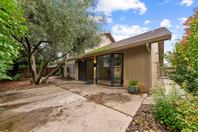 a front view of a house with a garden