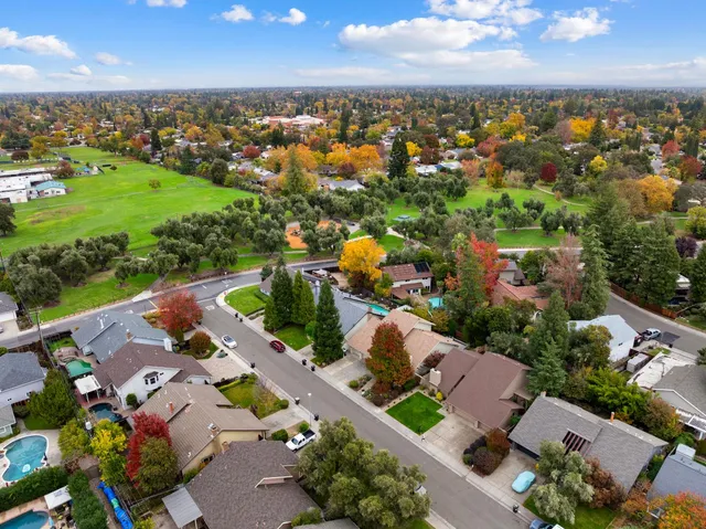 an aerial view of residential houses with outdoor space