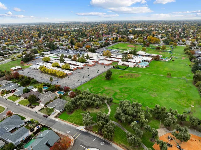 an aerial view of residential houses with outdoor space