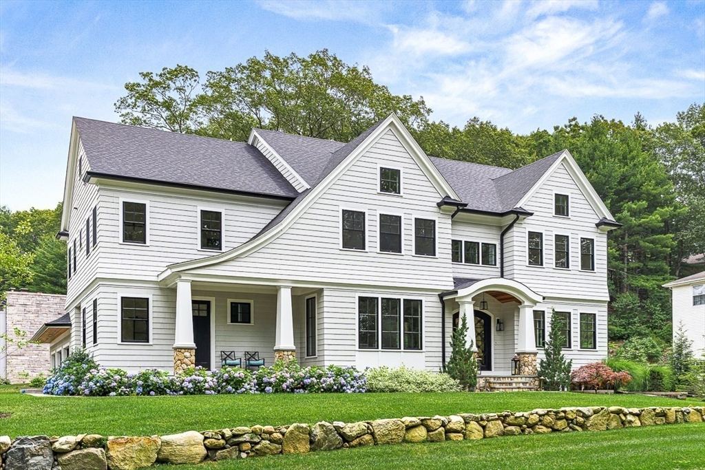54 Johnson Road Winchester, MA 01890 - Photo 42 of 42 a front view of a house with a yard and potted plants