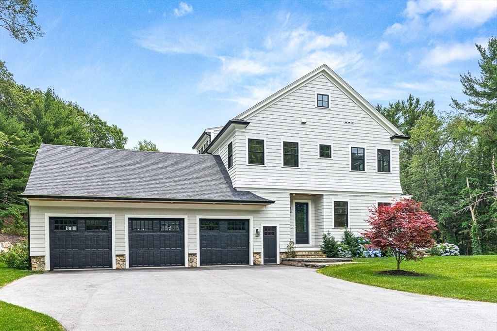 54 Johnson Road Winchester, MA 01890 - Photo 5 of 42 a front view of a house with a yard and garage