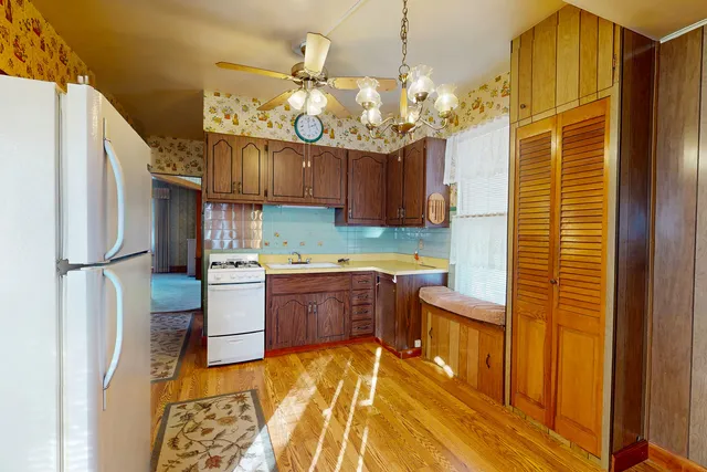 a kitchen with cabinets a sink stainless steel appliances and a window