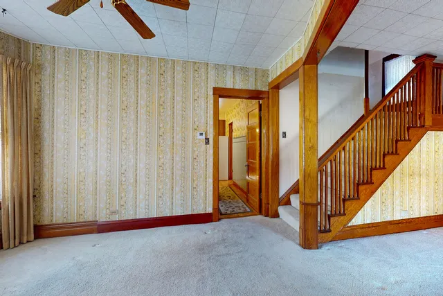 a view of an empty room with stairs