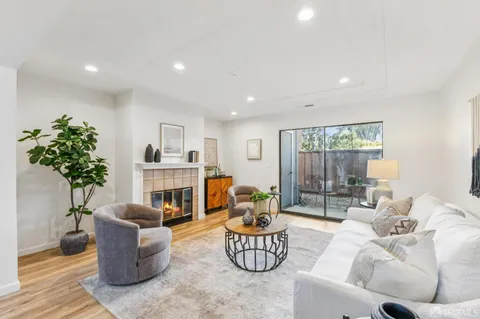 a living room with furniture potted plant and a fireplace