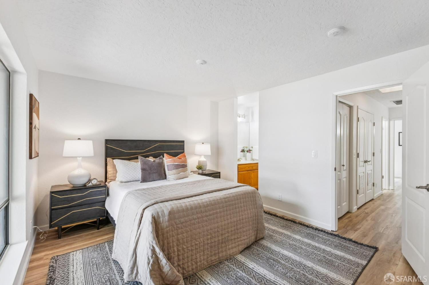 36931 Newark Boulevard, Unit E Newark, CA 94560 - Photo 18 of 37 a bedroom with a bed and wooden floor