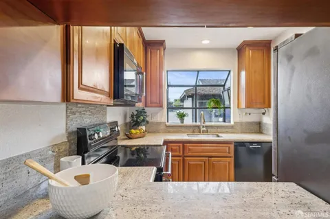 a kitchen with a sink a stove and cabinets