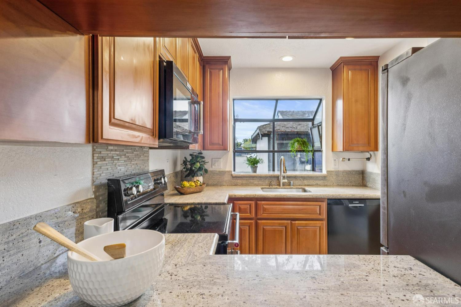 36931 Newark Boulevard, Unit E Newark, CA 94560 - Photo 5 of 37 a kitchen with a sink a stove and cabinets