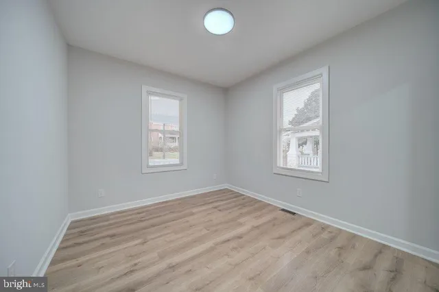 an empty room with windows and closet