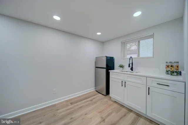a kitchen with a sink and refrigerator
