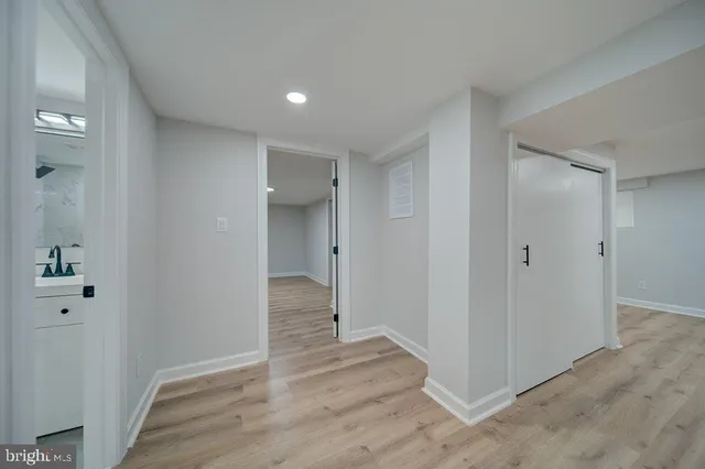 a view of a hallway with wooden floor