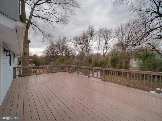 a view of a balcony with wooden floor and fence