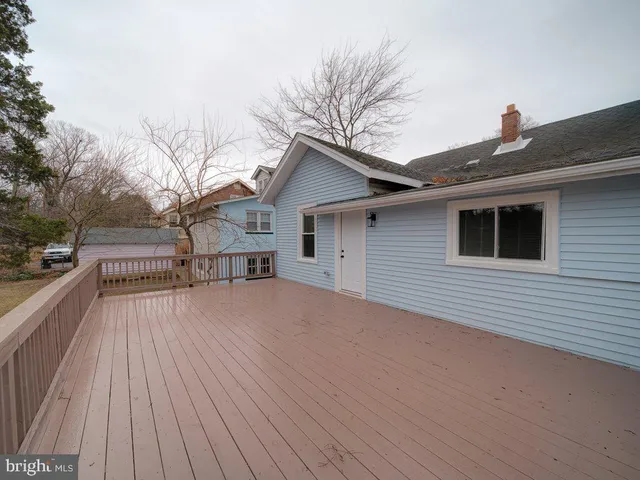 a view of house with yard and wooden floor
